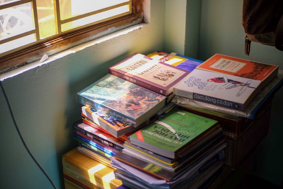 A cozy stack of books illuminated by morning sunlight, capturing peaceful vibes in Hue, Vietnam.